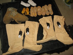 Beautiful custom made fleece  lined His & Hers Mukluks in the front, with beaded, lined mitts and an array of kid’s moccasins.  Tiny  booties make a terrific & unique  baby shower gift!
