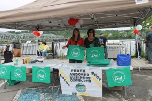 Rochelle Pelletier and Stacey Kelley dish out free hot dogs along with Think Local First gifts