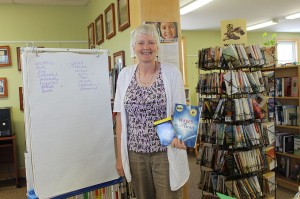 M.J. Domet is an Author, Healing Facilitator, Inspirational Speaker and Workshop Leader. M.J. is holding her book `Waves of Blue Light` and Waves of Blue Light Guidance Cards.