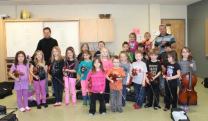 Emmanuel Ortega and Director David Halpine with a class of young musicians in the Sistema Music Program at Mah Sos School at Tobique First Nation