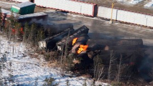 Derailed train cars carrying crude oil and propane burn in Wapske  