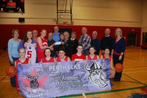 PAMs Varsity Basketball Team Captain Jayden O’Keefe receives the generous $4,000 cheque from Elk Ron Dube as Elks Club members look on. Assistant coaches Dawn Dickson and Adena Robinson are at either end, PAMs Head Coach Jon Brain is in the very back. 