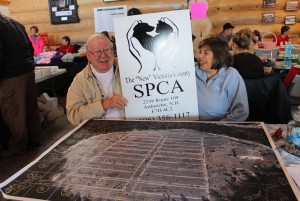 SPCA Volunteers Ray & Sharon man the table as they sell SPCA Pond Hockey Fund Raiser raffle tickets for some very cool prizes...