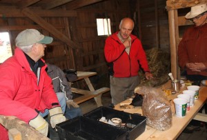 Mycologist David Boyle (centre) lays out the tools and ingredients needed for growing shiitake mushrooms on logs