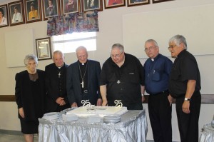 Rejeanne Beaulieu, Father Alfred Irving, Bishop Emeritus Gerard Dionne, Father Gilbert Doddatto,  Father Claude Thibodeau and Father Curtis Sappier cut the Anniversary Cake