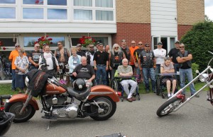 Victoria Glen Manor residents Neil Hamilton, Roland Miller & Val McLean enjoy a visit from Toy Run participants 